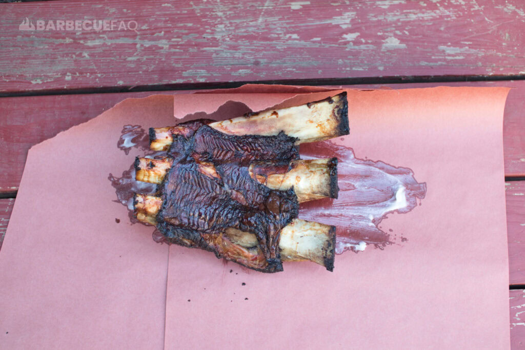 beef ribs meat side down in butcher paper with beef tallow smeared on the surface