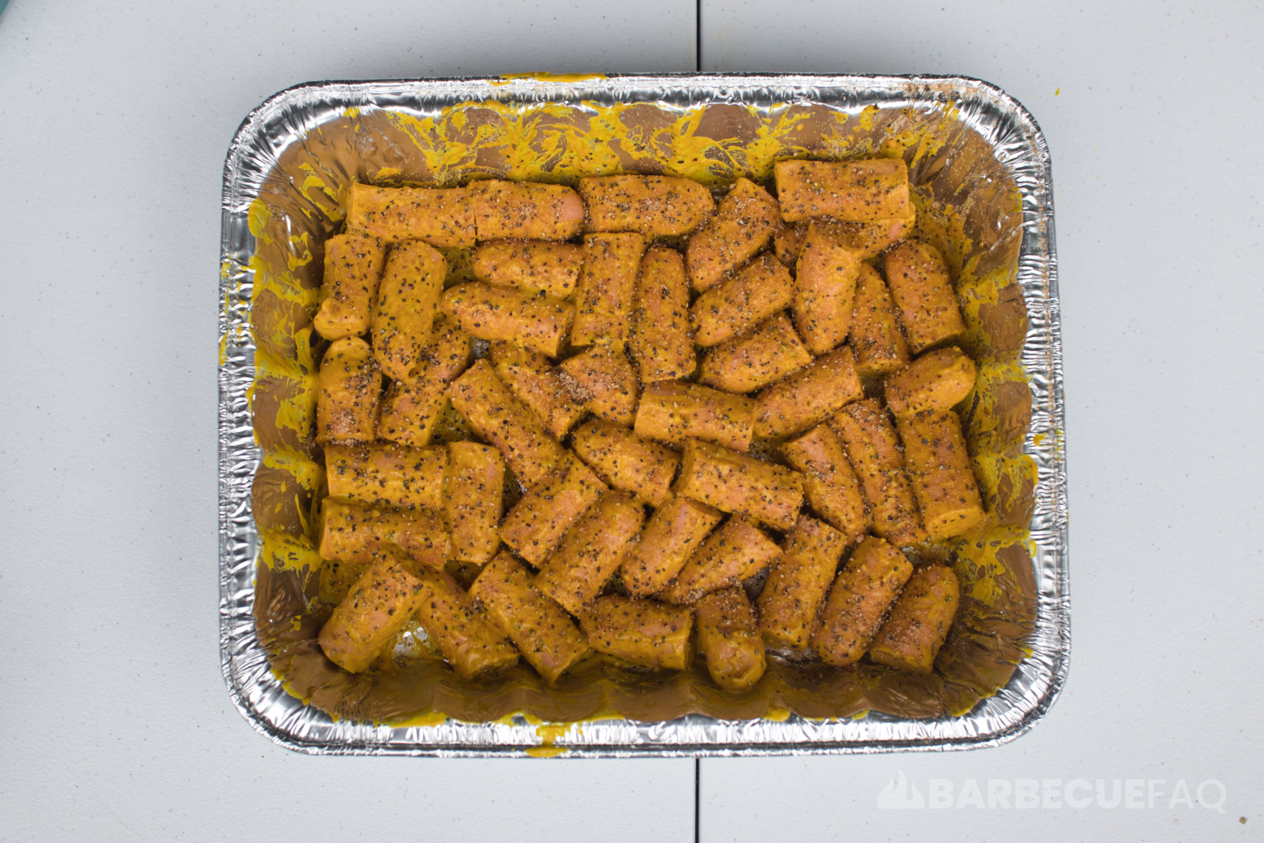 hot dogs covered in mustard binder with rub