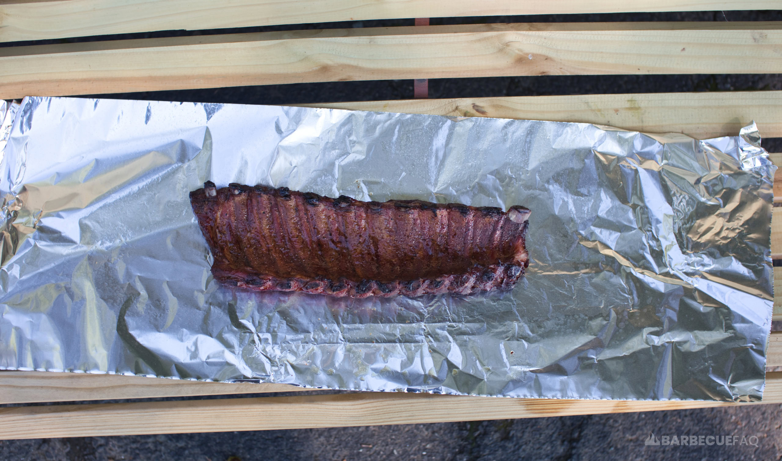 https://barbecuefaq.com/wp-content/uploads/2022/09/ribs-bone-side-down-in-wrap.jpg