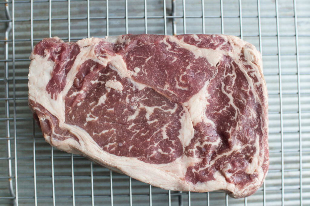 a ribeye steak on a wire rack