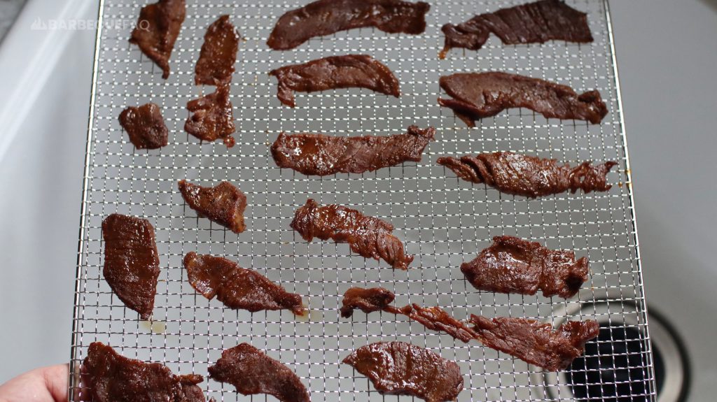 arranging the beef jerky on the dehydrator sheets so it doesn't overlap