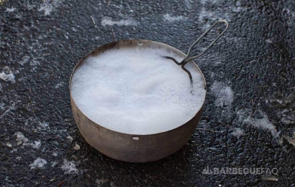 charcoal basket filled with warm soapy water