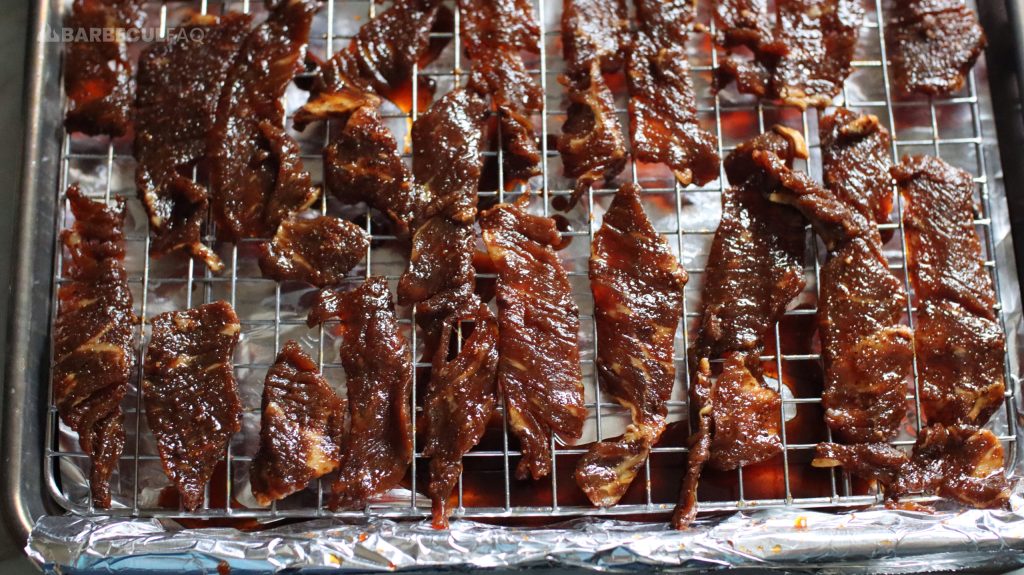 marinated meat on baking sheet