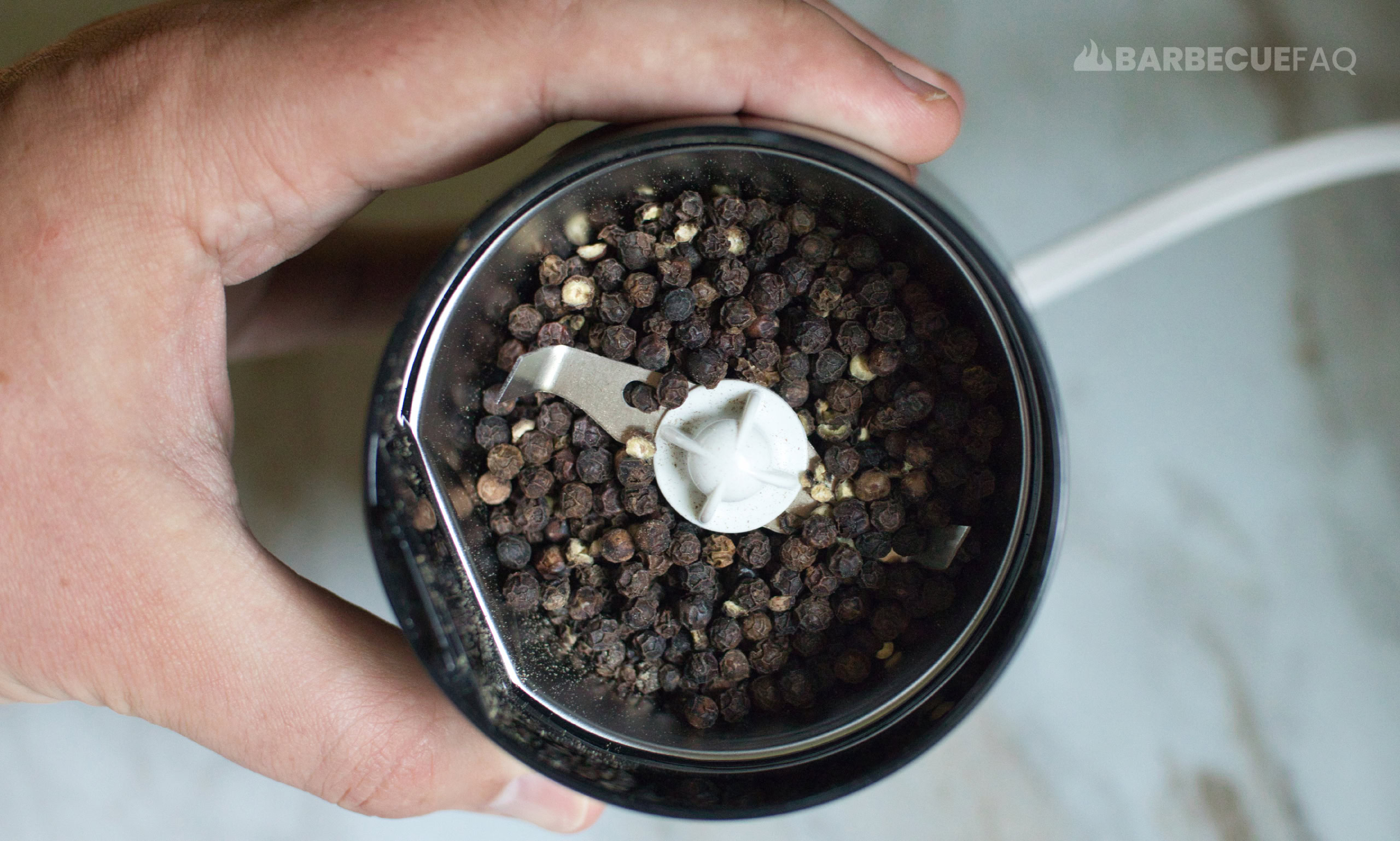 grinding peppercorns in spice grinder