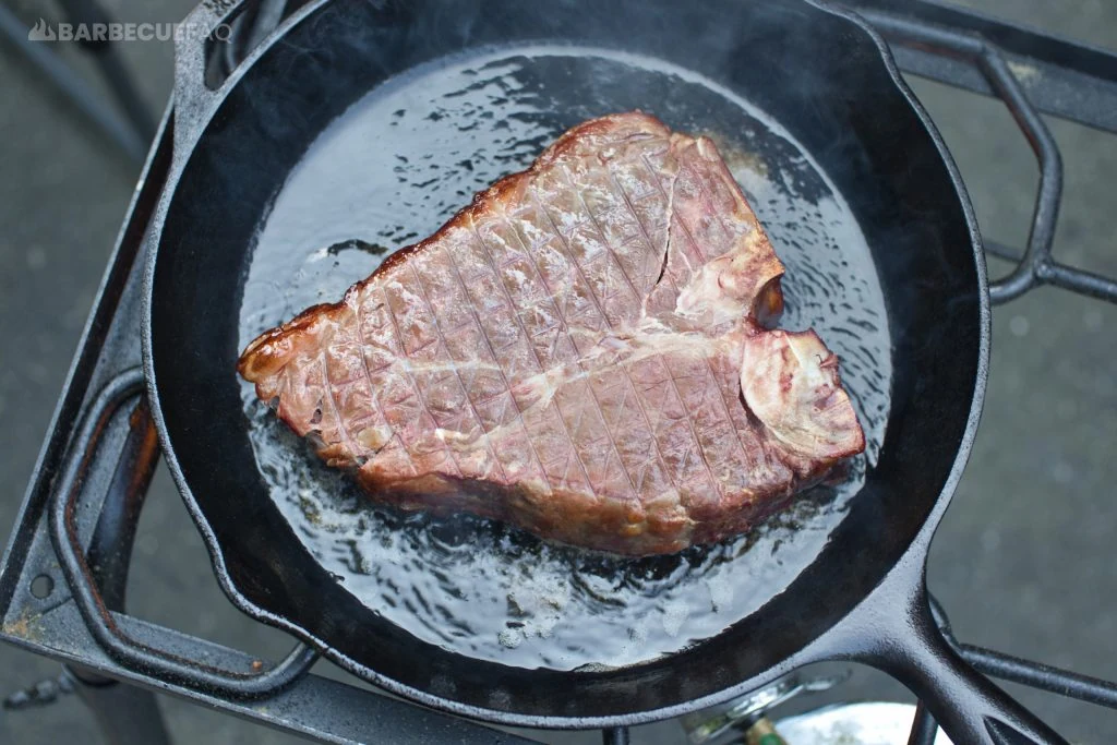 searing porterhouse steak first side