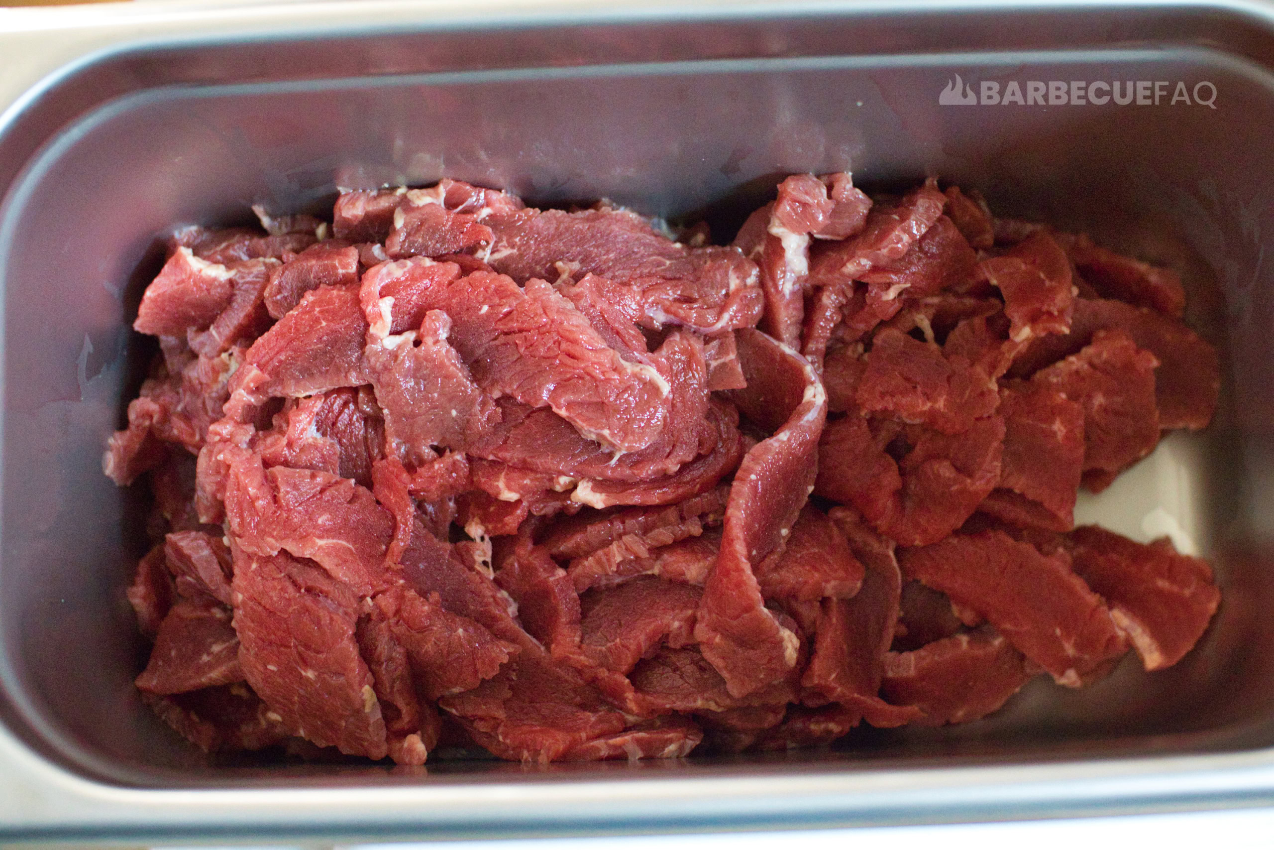 beef jerky sliced into container