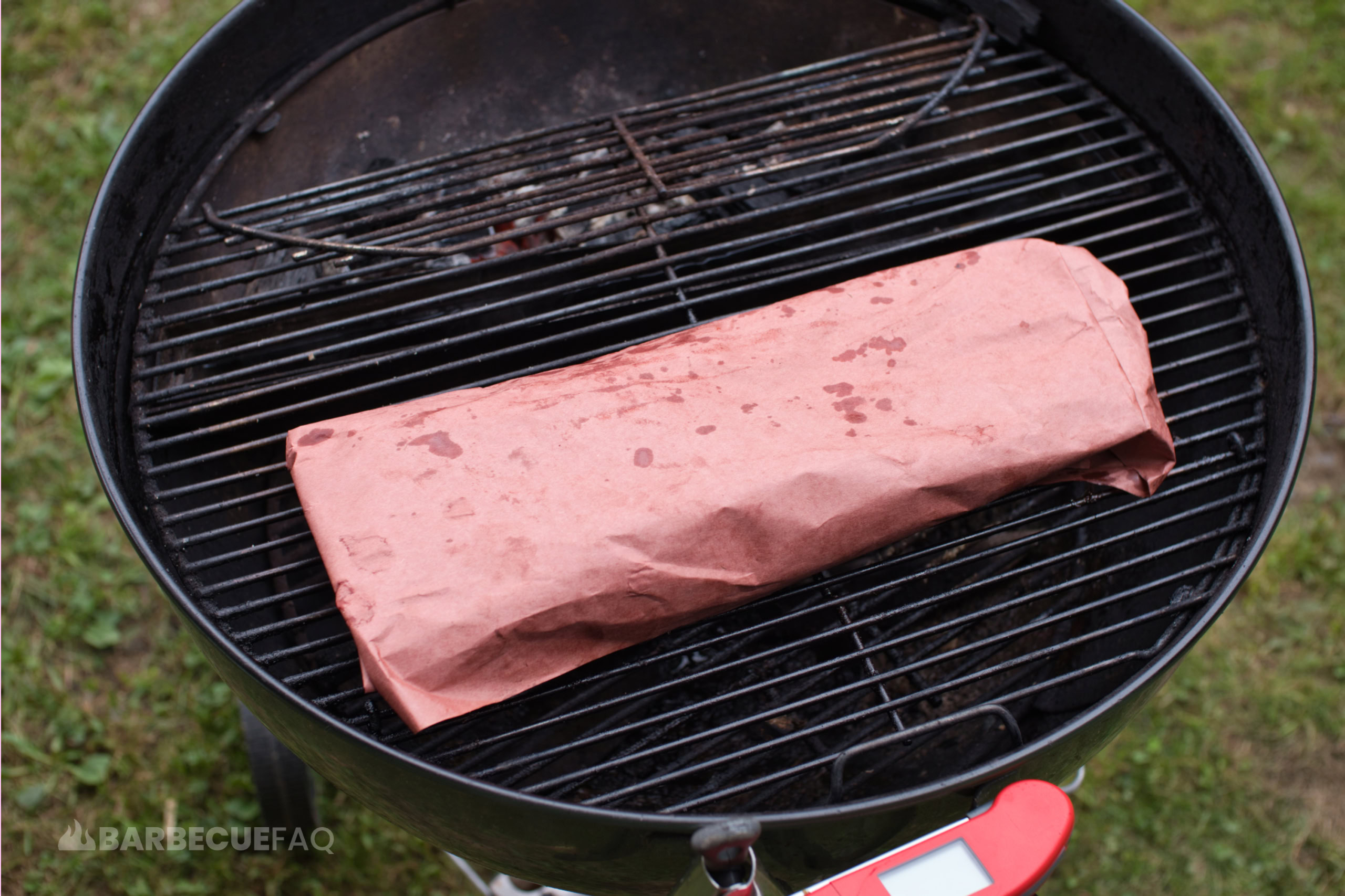 ribs wrapped in butcher paper on smoker