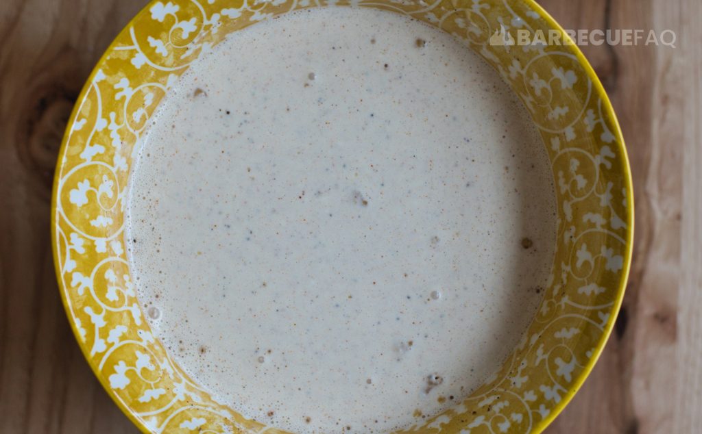 mixing the white sauce ingredients in a regular bowl