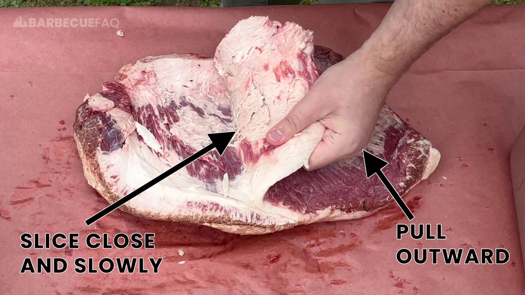 pull the brisket flat with your non-knife hand to create leverage