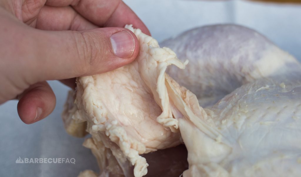 removing the excess skin and fat from chicken thighs