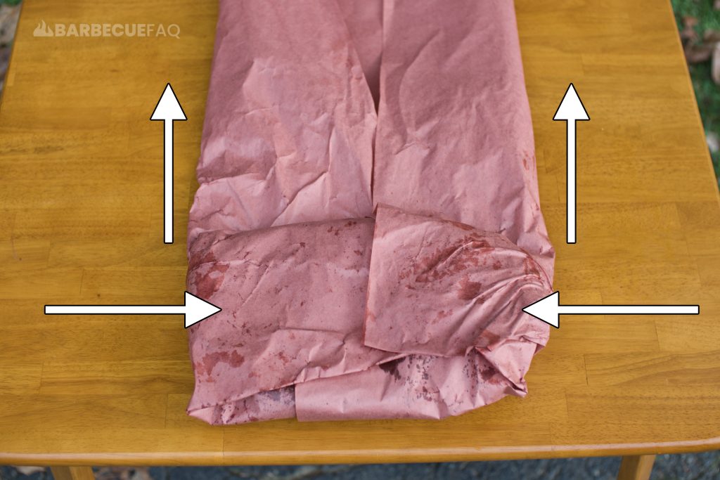 fold the edges over the brisket and then crease the remaining paper