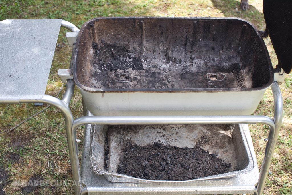 ash dumped into an aluminum pan set on the shelf below the pk grill