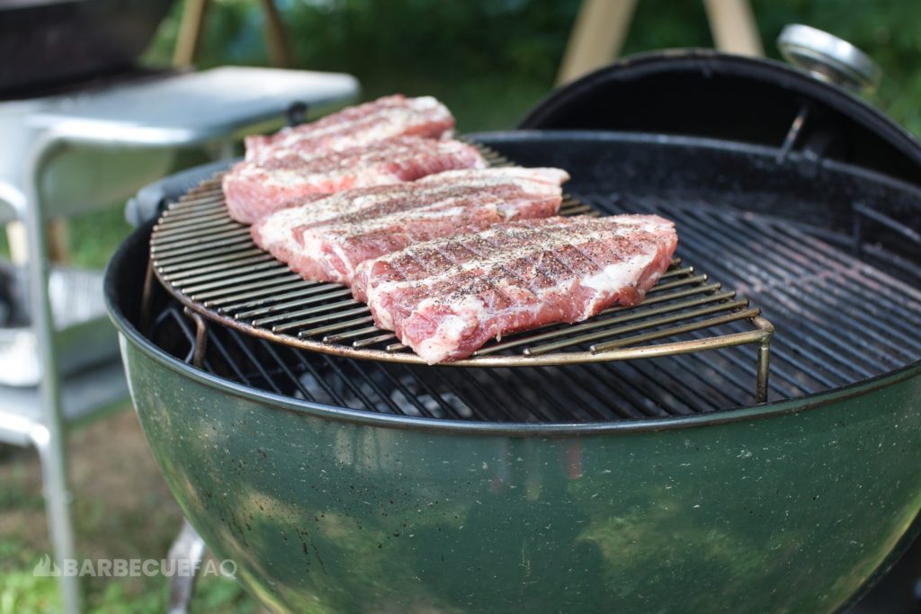 pork steaks elevated on grill