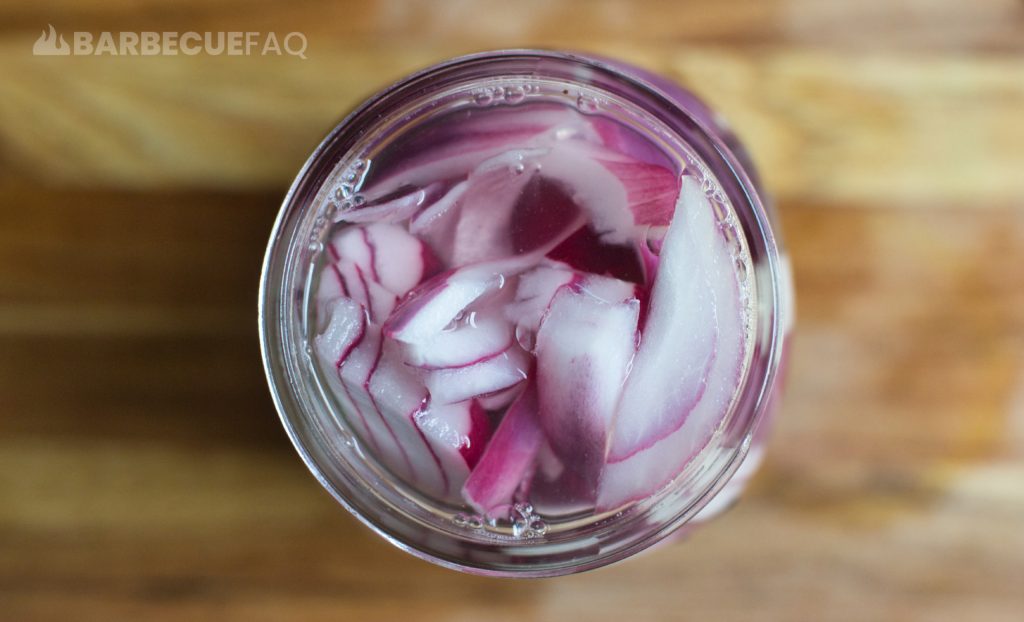 top down view of pickled red onions in mason jar