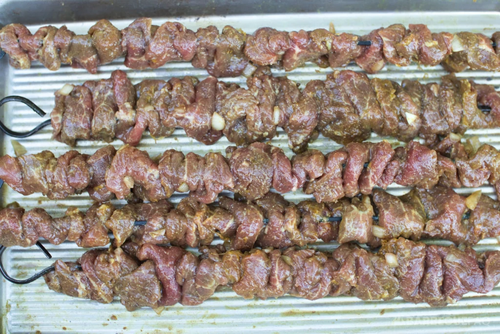 putting beef on a skewer