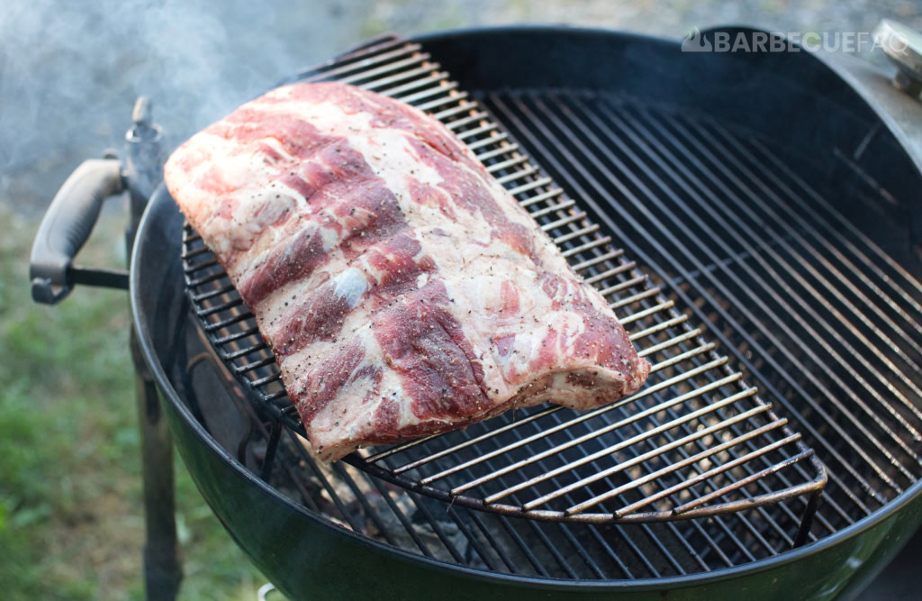 beef back ribs elevated on grill grate