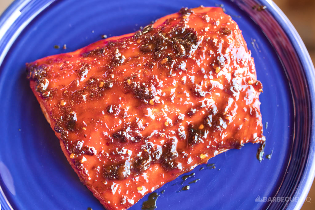 chili crisp glazed grilled salmon on a blue plate