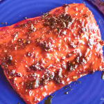 chili crisp glazed grilled salmon on a blue plate