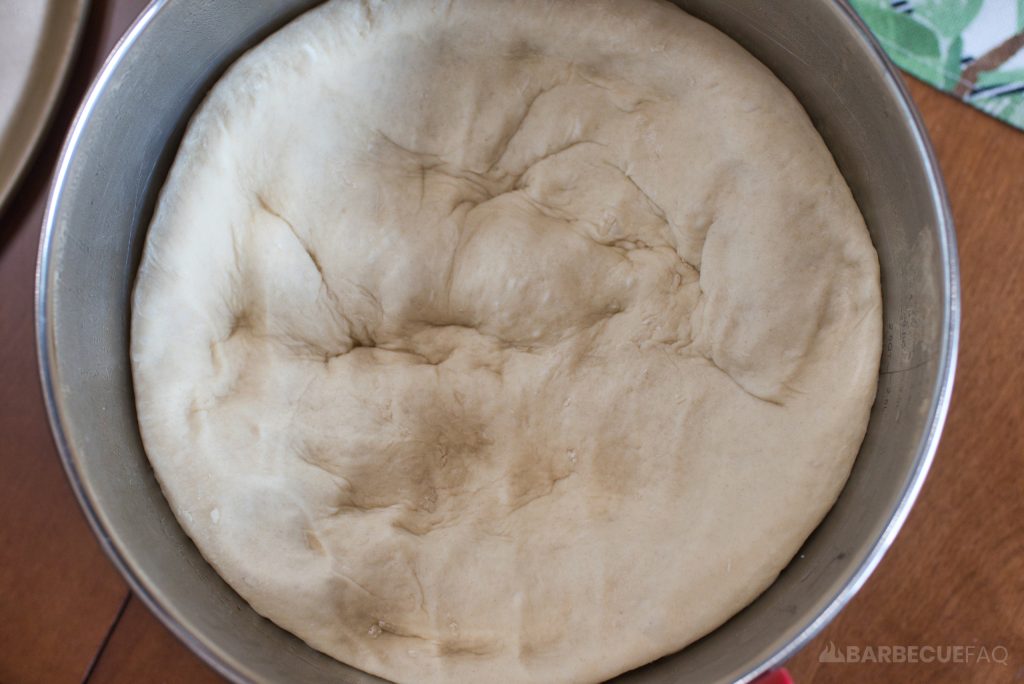 top down view of dough in ball after being punched down 5 times